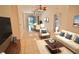 Bright living room and dining area with tile floors and modern furnishings, with views to the screened-in patio at 4264 Central Sarasota Pkwy # 116, Sarasota, FL 34238