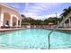 Inviting community pool surrounded by sun loungers and lush landscaping at 4264 Central Sarasota Pkwy # 116, Sarasota, FL 34238