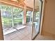 Enclosed patio with tile floors and screened windows offering views of the landscaped greenery at 4264 Central Sarasota Pkwy # 116, Sarasota, FL 34238
