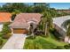 Lovely home with a tile roof, lush landscaping, and a well-manicured lawn at 4435 Beauchamp Ct, Sarasota, FL 34243