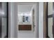 Elegant bathroom showcasing dual sinks, sleek vanities, and modern fixtures through an open doorway at 4435 Beauchamp Ct, Sarasota, FL 34243