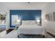 Bright bedroom featuring a blue accent wall and sliding glass doors to the outdoor pool area at 4435 Beauchamp Ct, Sarasota, FL 34243