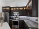 Contemporary kitchen featuring granite counters, stainless appliances, and updated lighting at 4435 Beauchamp Ct, Sarasota, FL 34243