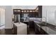 Well-equipped kitchen with stainless steel appliances, an island, and dark wood cabinetry at 4435 Beauchamp Ct, Sarasota, FL 34243