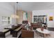 Open-concept living room with a dining area, fireplace, and access to the lanai at 4435 Beauchamp Ct, Sarasota, FL 34243