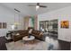 Inviting living room with a fireplace, leather sectional, and access to the screened lanai at 4435 Beauchamp Ct, Sarasota, FL 34243