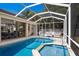 Backyard with screened in pool and spa, outdoor kitchen, dining and lounge area at 4435 Beauchamp Ct, Sarasota, FL 34243