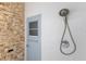 Convenient outdoor shower with stone accent wall near pool exit at 4435 Beauchamp Ct, Sarasota, FL 34243