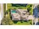 Aerial view showcases a home with a screened-in pool, and a beautiful brick driveway at 4579 Tuscana Dr, Sarasota, FL 34241