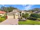 Aerial view of home with lush backyard, pool, mature trees and brick driveway at 4579 Tuscana Dr, Sarasota, FL 34241