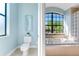 Bathroom features a toilet area and a tub and shower combo area with lots of natural light at 4579 Tuscana Dr, Sarasota, FL 34241