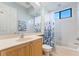 Bright bathroom features a tub-shower combo, vanity, and light wood cabinet at 4579 Tuscana Dr, Sarasota, FL 34241