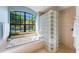 Bathroom showcasing a large soaking tub with a garden view and a glass block shower at 4579 Tuscana Dr, Sarasota, FL 34241