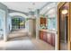 Bright bathroom features a soaking tub under a large window and a glass block shower at 4579 Tuscana Dr, Sarasota, FL 34241