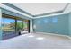 Carpeted bedroom with recessed lighting offers sunny balcony views and is painted a peaceful blue at 4579 Tuscana Dr, Sarasota, FL 34241