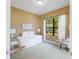 Cozy bedroom featuring a queen-sized bed, soft carpet, natural light, and a serene view of the outdoors at 4579 Tuscana Dr, Sarasota, FL 34241