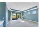 Light blue bedroom features recessed lights, carpet, access to a screened in balcony, and natural sunlight at 4579 Tuscana Dr, Sarasota, FL 34241