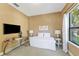 Comfortable bedroom with a decorative accent wall, plush carpet, and an attractive window that lets in natural light at 4579 Tuscana Dr, Sarasota, FL 34241