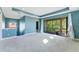 Spacious carpeted bedroom offers access to the screened-in balcony and additional natural light at 4579 Tuscana Dr, Sarasota, FL 34241