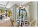 Dining area with seating for four and views of the pool area through sliding glass doors at 4579 Tuscana Dr, Sarasota, FL 34241