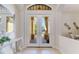 Elegant entryway featuring double doors with glass panels and an arched transom window at 4579 Tuscana Dr, Sarasota, FL 34241