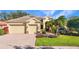 Beautiful home with lush landscaping, a brick driveway, and meticulously manicured lawn at 4579 Tuscana Dr, Sarasota, FL 34241