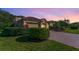 Home featuring lush landscaping, a brick driveway, and a meticulously manicured lawn at 4579 Tuscana Dr, Sarasota, FL 34241