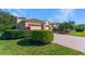 Home featuring lush landscaping, a brick driveway, and a meticulously manicured lawn at 4579 Tuscana Dr, Sarasota, FL 34241