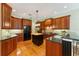 This kitchen boasts dark wood cabinets, stone countertops, and a center island with butcher block top at 4579 Tuscana Dr, Sarasota, FL 34241