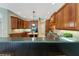 An open kitchen features custom wood cabinets, granite countertops and island with sink at 4579 Tuscana Dr, Sarasota, FL 34241