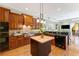 Kitchen featuring dark wood cabinets, stone countertops, a center island, and stainless steel appliances at 4579 Tuscana Dr, Sarasota, FL 34241