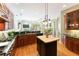 Kitchen features dark wood cabinets, stone countertops, a center island, and hardwood flooring at 4579 Tuscana Dr, Sarasota, FL 34241