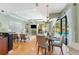 Open concept living and dining area with hardwood floors and views of the pool at 4579 Tuscana Dr, Sarasota, FL 34241