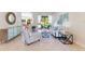 Bright living room with tile flooring, stylish furnishings, and open access to the pool area at 4579 Tuscana Dr, Sarasota, FL 34241