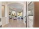 Elegant living room with tile flooring, tray ceiling, and seamless access to outdoor living spaces at 4579 Tuscana Dr, Sarasota, FL 34241