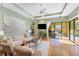 Comfortable living room with hardwood floors, a ceiling fan, and sliding glass doors to the patio at 4579 Tuscana Dr, Sarasota, FL 34241