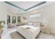 Light-filled main bedroom with tray ceiling and a cozy sitting area at 4579 Tuscana Dr, Sarasota, FL 34241