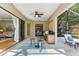Covered outdoor patio features a bar and seating area with views of the living room and pool at 4579 Tuscana Dr, Sarasota, FL 34241