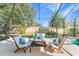 Covered patio has outdoor seating with cushions and a view to the lawn in screened enclosure at 4579 Tuscana Dr, Sarasota, FL 34241