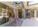 Outdoor patio has seating and views to the interior through the sliding glass doors and windows at 4579 Tuscana Dr, Sarasota, FL 34241