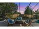 A screened-in outdoor patio area with comfortable seating and tranquil views of the backyard at 4579 Tuscana Dr, Sarasota, FL 34241