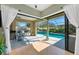 Outdoor pool area featuring a screened-in enclosure with a patio, bar and seating at 4579 Tuscana Dr, Sarasota, FL 34241