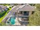 Aerial view of the screened-in pool and outdoor seating area and covered veranda on the second floor at 4579 Tuscana Dr, Sarasota, FL 34241