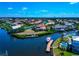 Beautiful aerial view of canal-front homes with boat docks in a waterfront community on a sunny day at 4700 Mainsail Dr, Bradenton, FL 34208