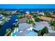 An aerial view of waterfront homes nestled along a canal, surrounded by lush landscaping with water views at 4700 Mainsail Dr, Bradenton, FL 34208