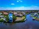 An aerial view of a waterfront home with private dock and boat lift along a canal at 4700 Mainsail Dr, Bradenton, FL 34208