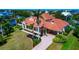 A stylish home with a carport, tile roof, well-kept lawn, and mature landscaping at 4700 Mainsail Dr, Bradenton, FL 34208