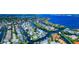 Panoramic aerial view of a coastal community featuring homes along deepwater canals with easy access to the open bay at 4700 Mainsail Dr, Bradenton, FL 34208