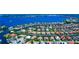An aerial view of a waterfront community with canal access to the ocean, showcasing beautiful homes and landscaping at 4700 Mainsail Dr, Bradenton, FL 34208