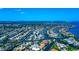 Overhead aerial view showcasing waterfront homes in a canal-lined community, offering direct access to the scenic bay at 4700 Mainsail Dr, Bradenton, FL 34208